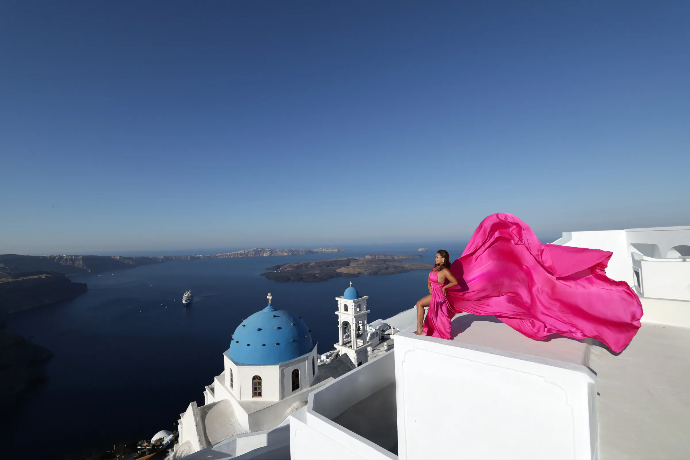 Flying dress photography overlooking Santorini
