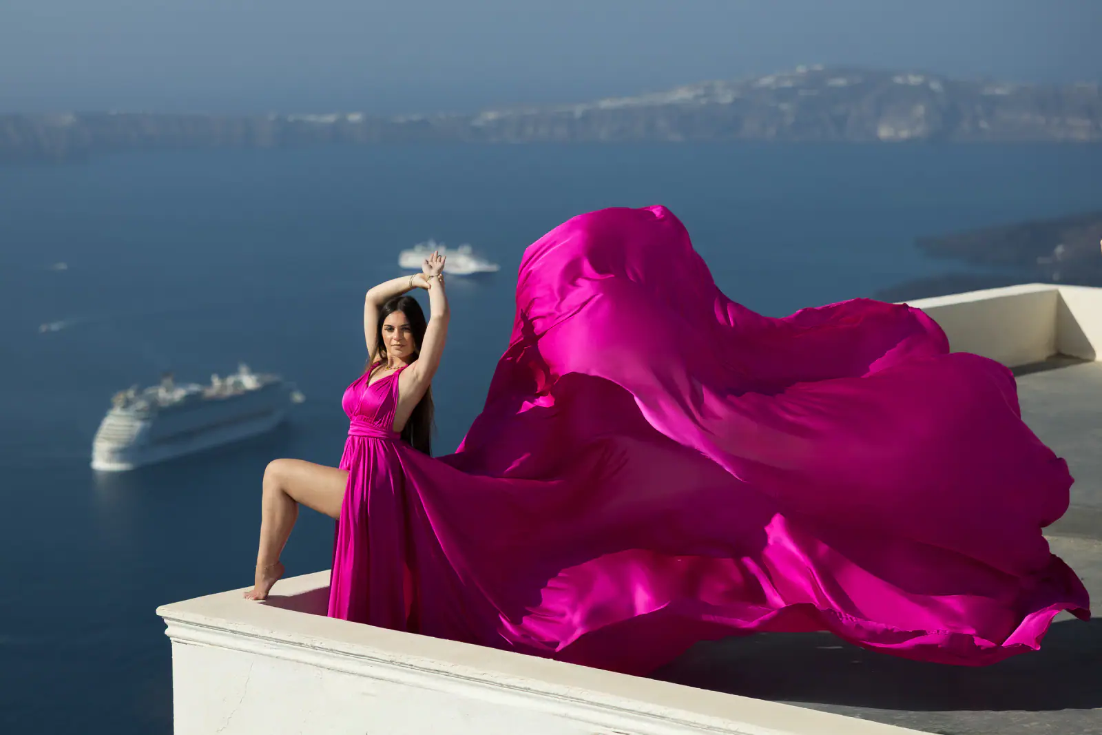 Pink flying dress portrait in Santorini