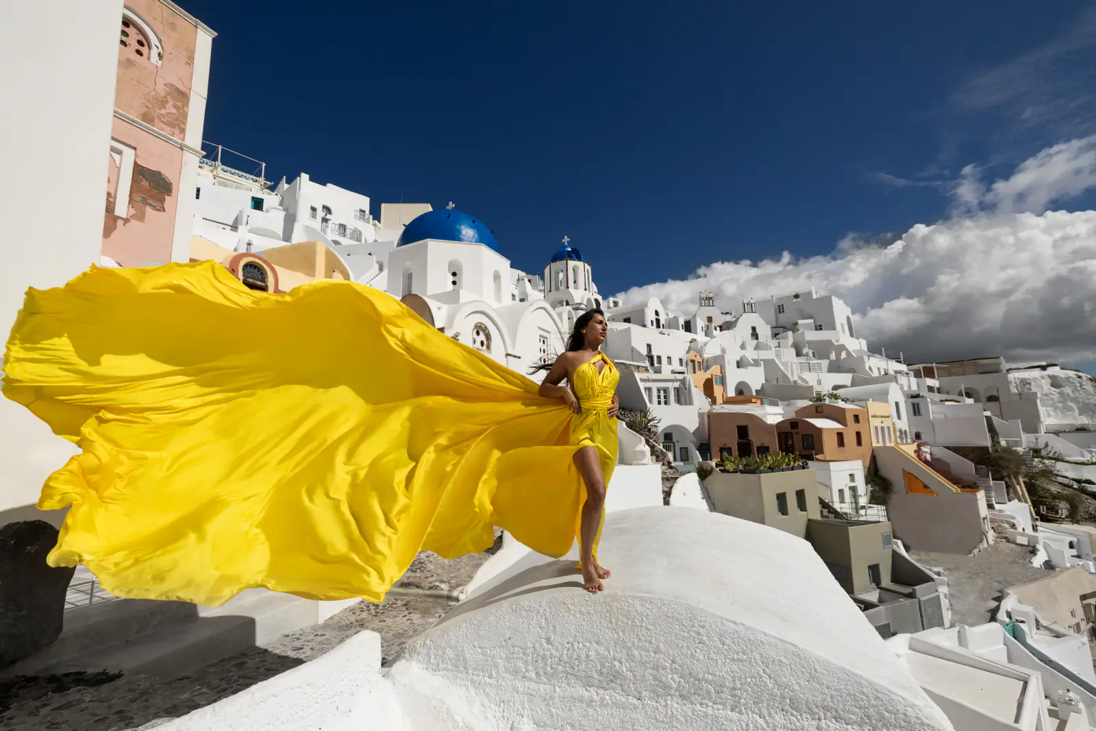 Golden flying dress portrait in Santorini