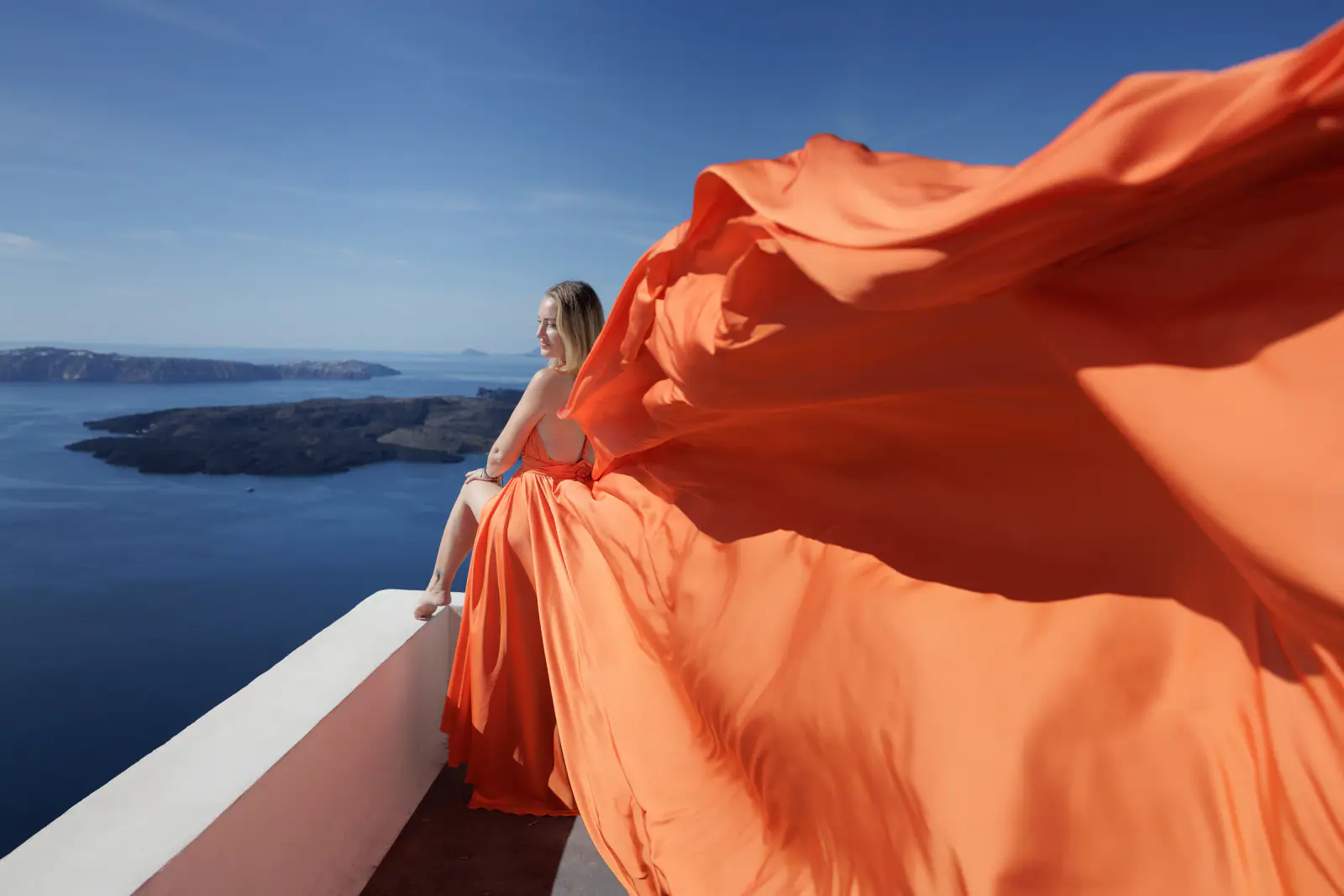 Orange flying dress portrait in Santorini