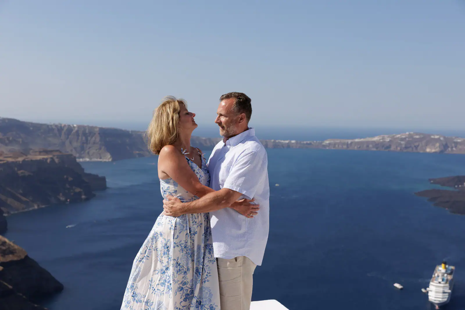 Couple holding each other with the volcanic islands behind them